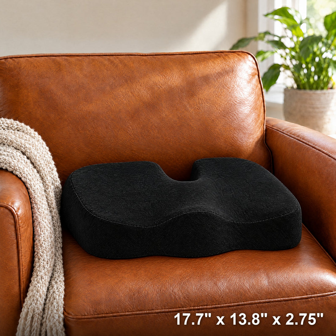 The black SatisfyComfort gel seat cushion on a leather armchair. Size: 17.7 x 13.8 x 2.75 inches