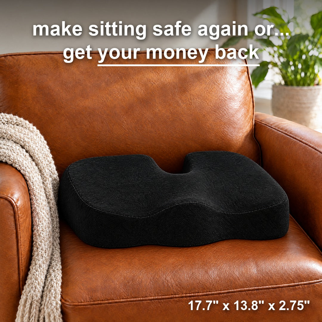 Black gel seat cushion on a brown leather armchair, tailbone cutout centered at the back. Make sitting safe again or get your money back. 17.7 x 13.8 x 2.75 in
